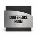 a sign that reads "CONFERENCE ROOM" in bold black letters, with a small amount of text in a different font size below it, indicating that the sign is designed to be accessible for people with visual impairments. - Photo #1