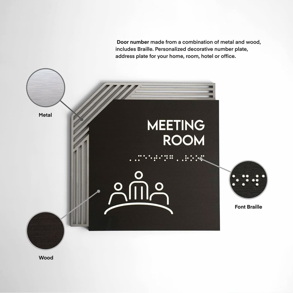 a black and white photo of a meeting room sign