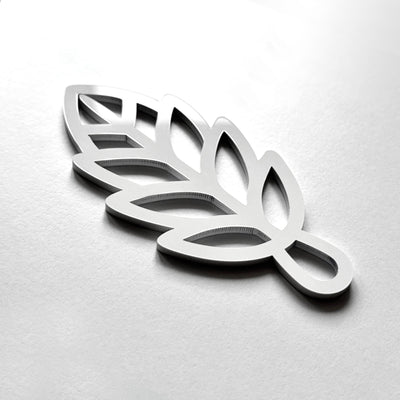 A 3D rendering of a stylized leaf-like shape in silver or metallic material.