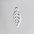 A white leaf-shaped object is centered against a plain white background. - Photo #9