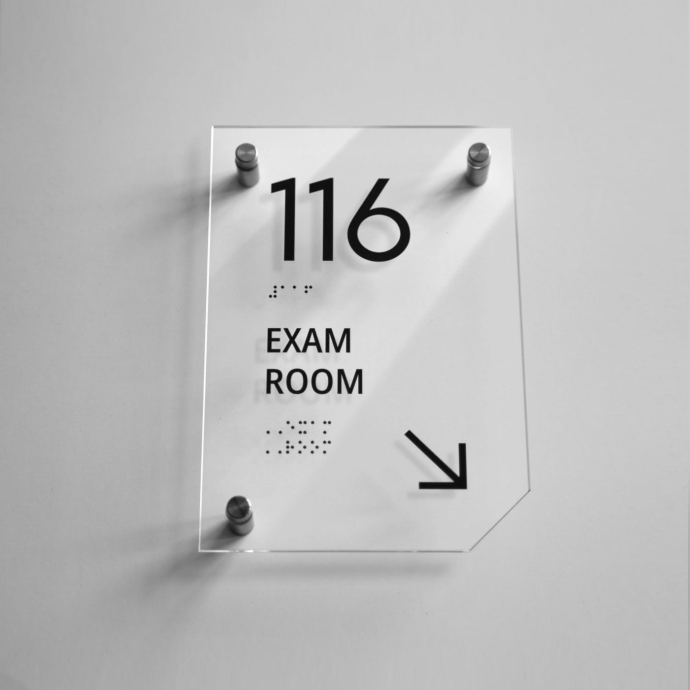 a glass sign with the words exam room on it