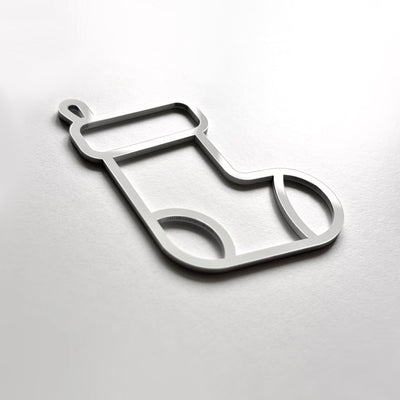 A simple, minimalist silver-colored stocking toy or ornament is shown against a plain white background.