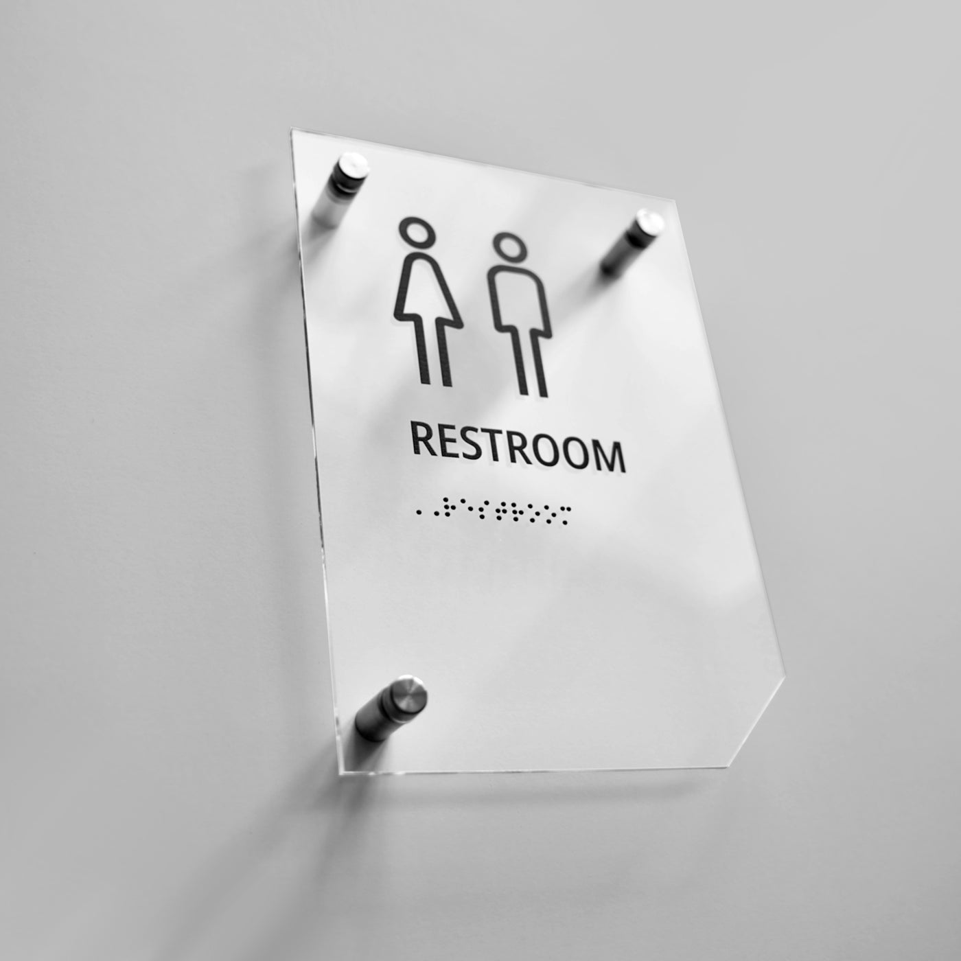 a restroom sign hanging on a wall