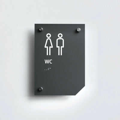 a bathroom sign on a white wall