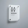 a restroom sign mounted on a wall - Photo #3