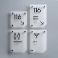 a set of four restroom signs mounted to the side of a wall - Photo #10