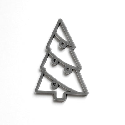 A simple, stylized Christmas tree cookie cutter in a gray color.