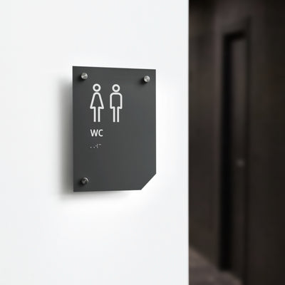 a black and white bathroom sign on a white wall