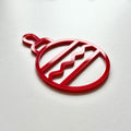 A red ornament with a wavy pattern is shown against a white background. - Photo #8